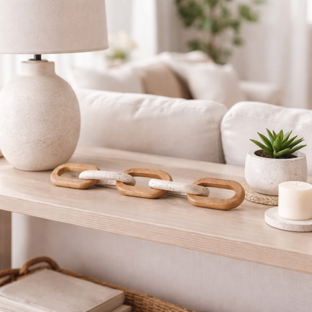 Decorative wooden chain on a coffee table with a lamp and plant in the background