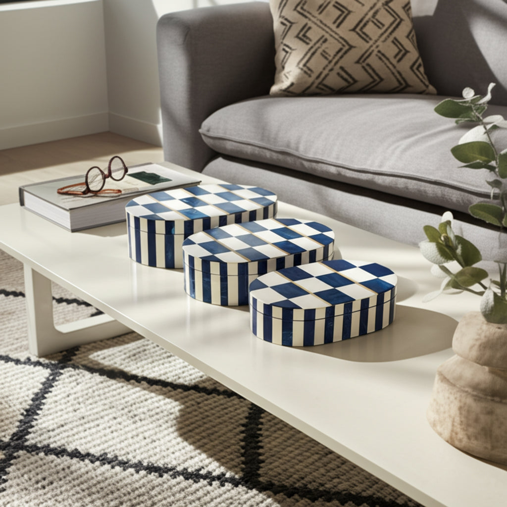 Three decorative boxes with blue and white checkered pattern on a coffee table in a living room.