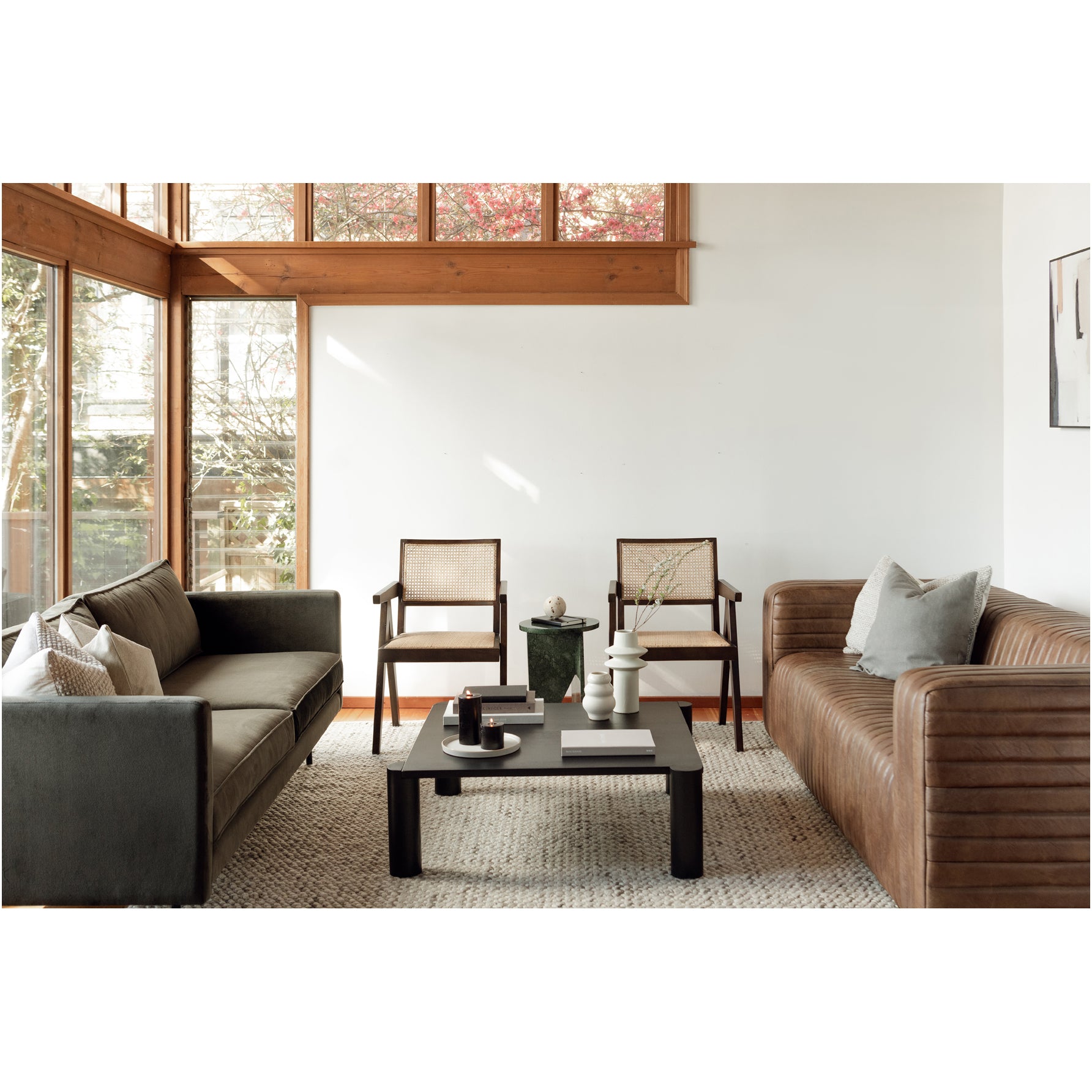 Modern living room with two sofas, a coffee table, and chairs.