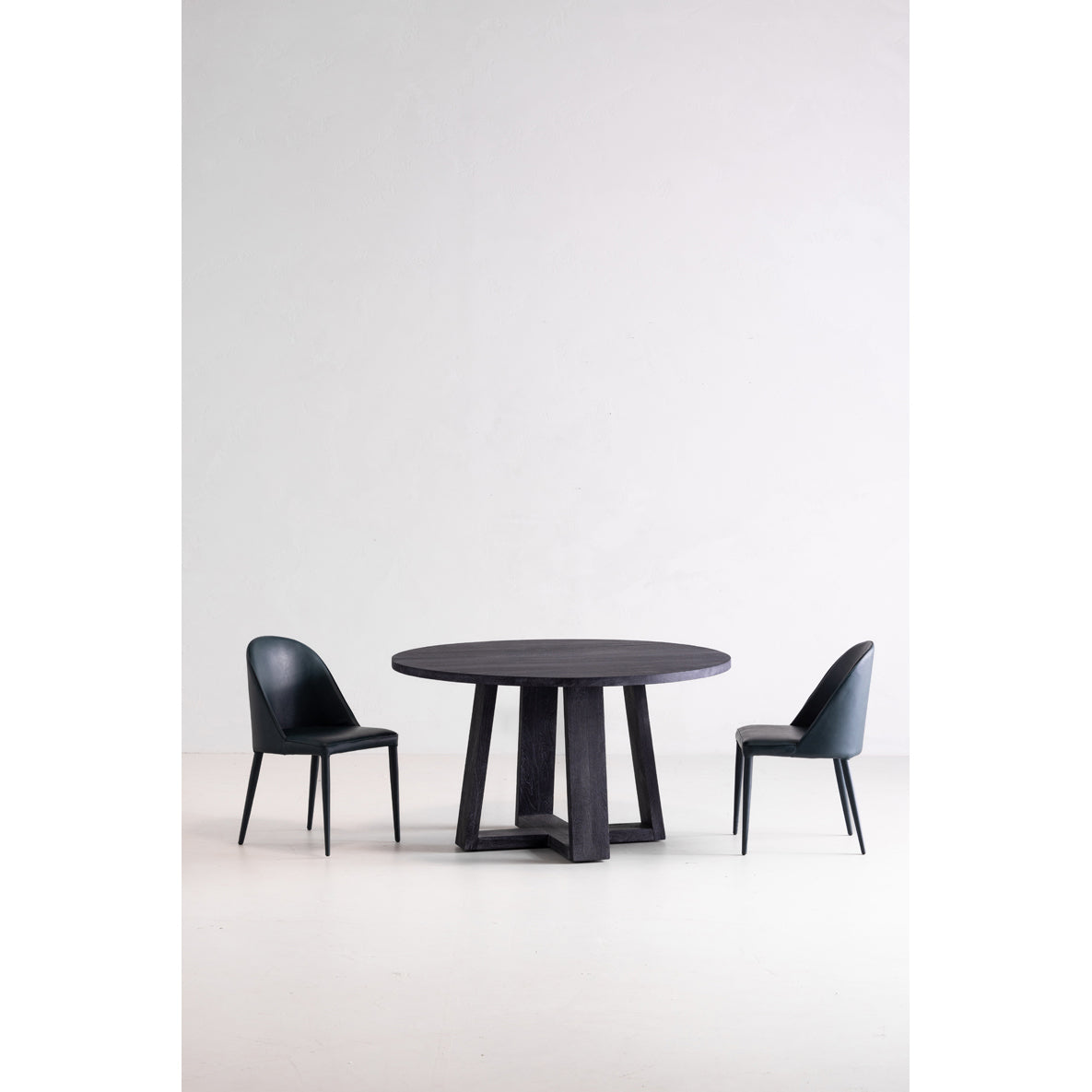 Round black table with two matching chairs on a white background