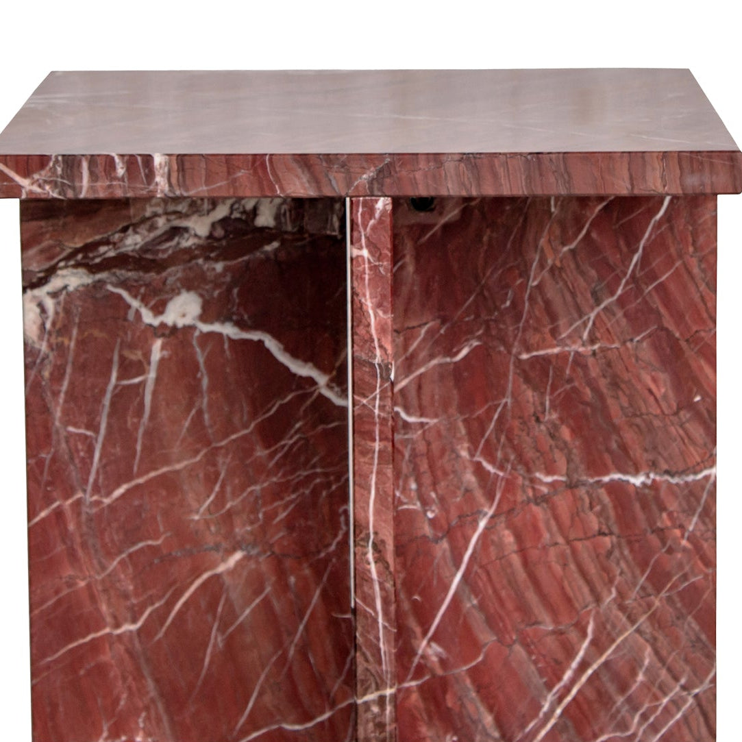 Red marble-patterned side table on a white background