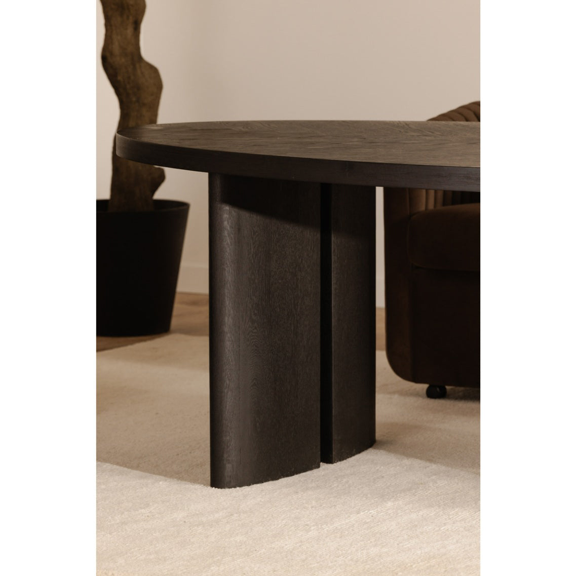 Dark wooden table with a textured surface and sturdy legs on a neutral background