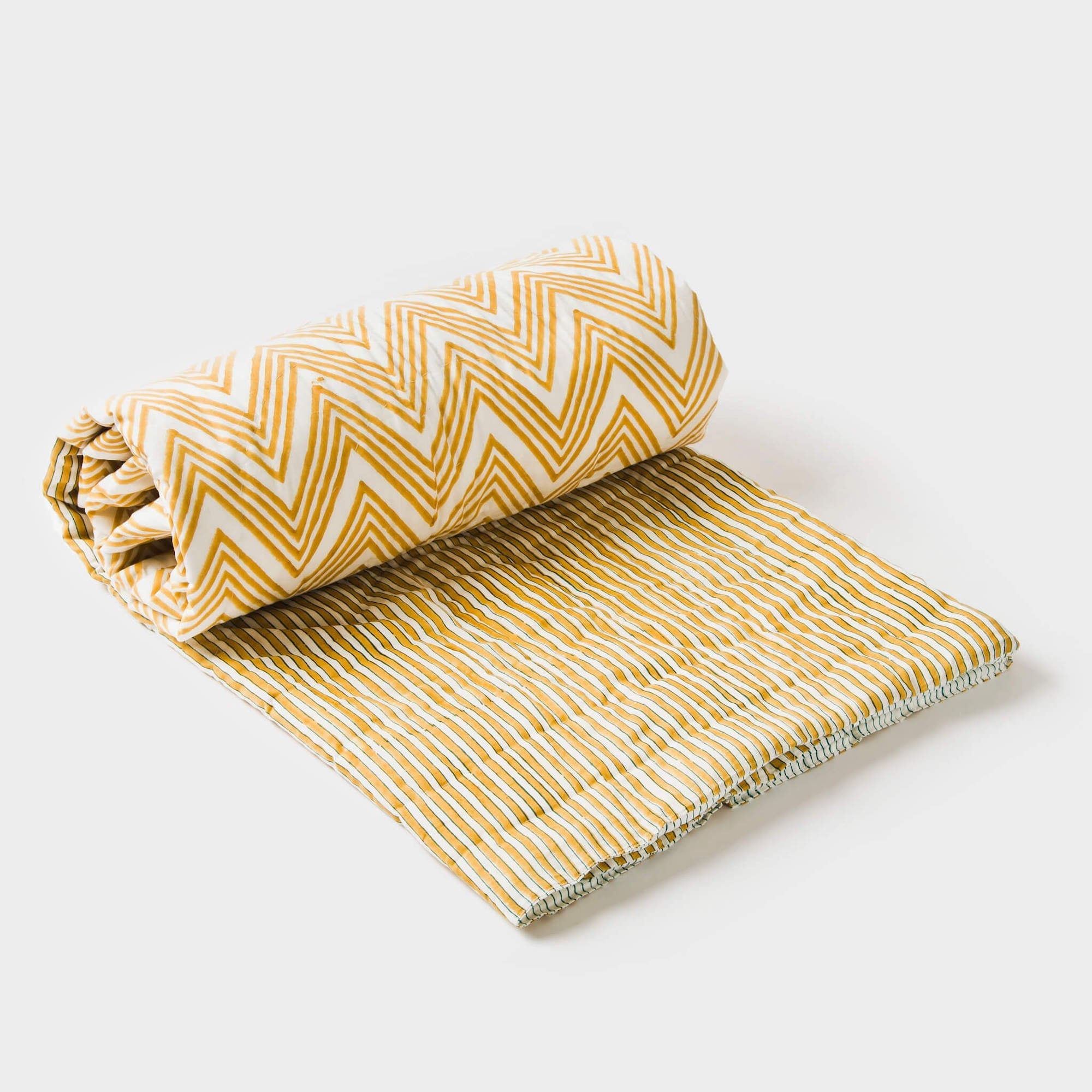 Yellow throw blanket with a zigzag pattern on a white background