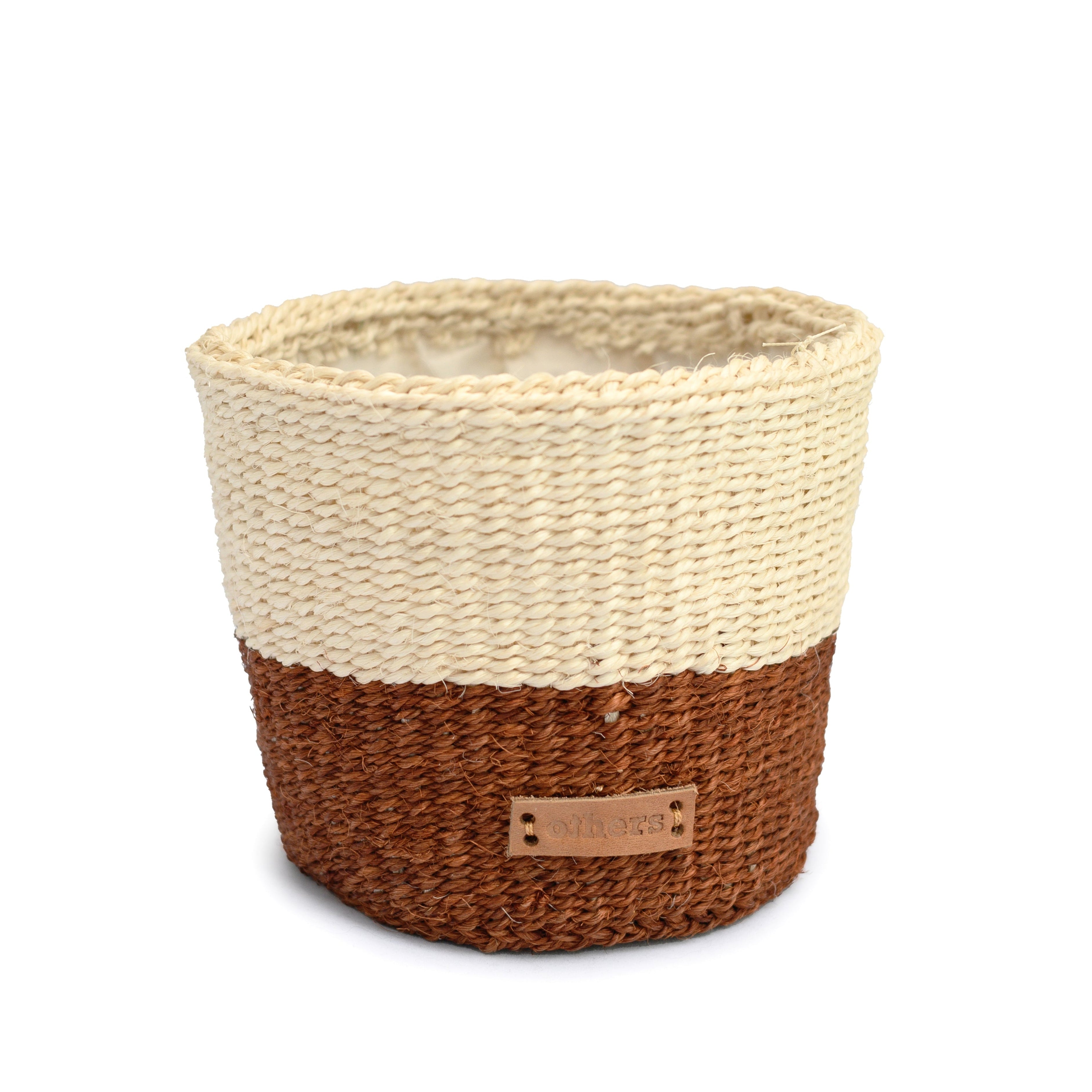 Woven basket with two-tone design on a white background