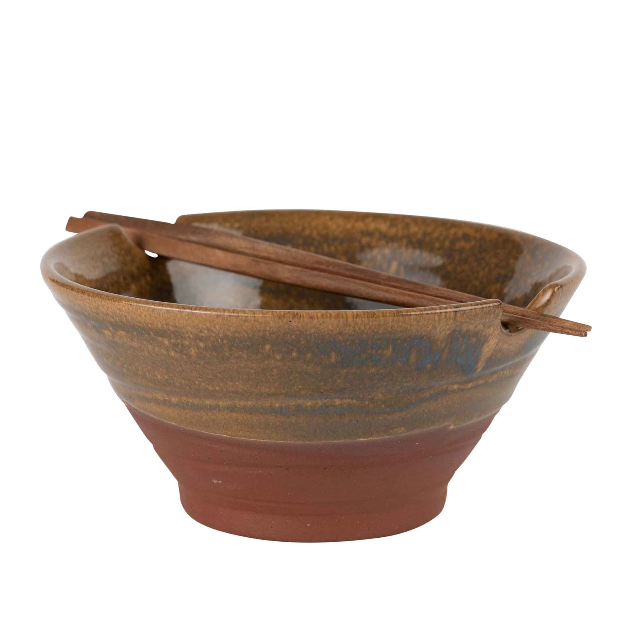 Brown ceramic bowl with wooden spoons on a white background