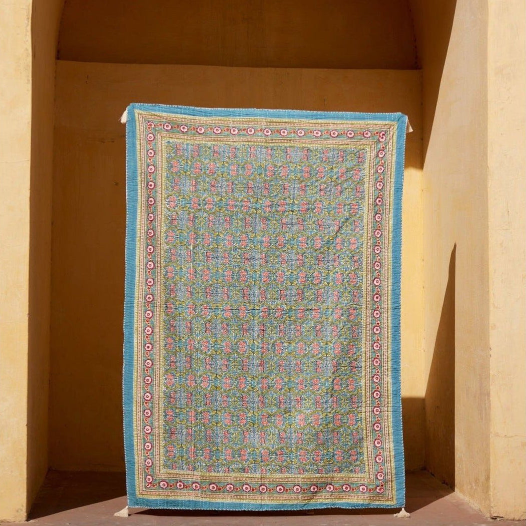 Decorative rug with intricate patterns draped over a archway
