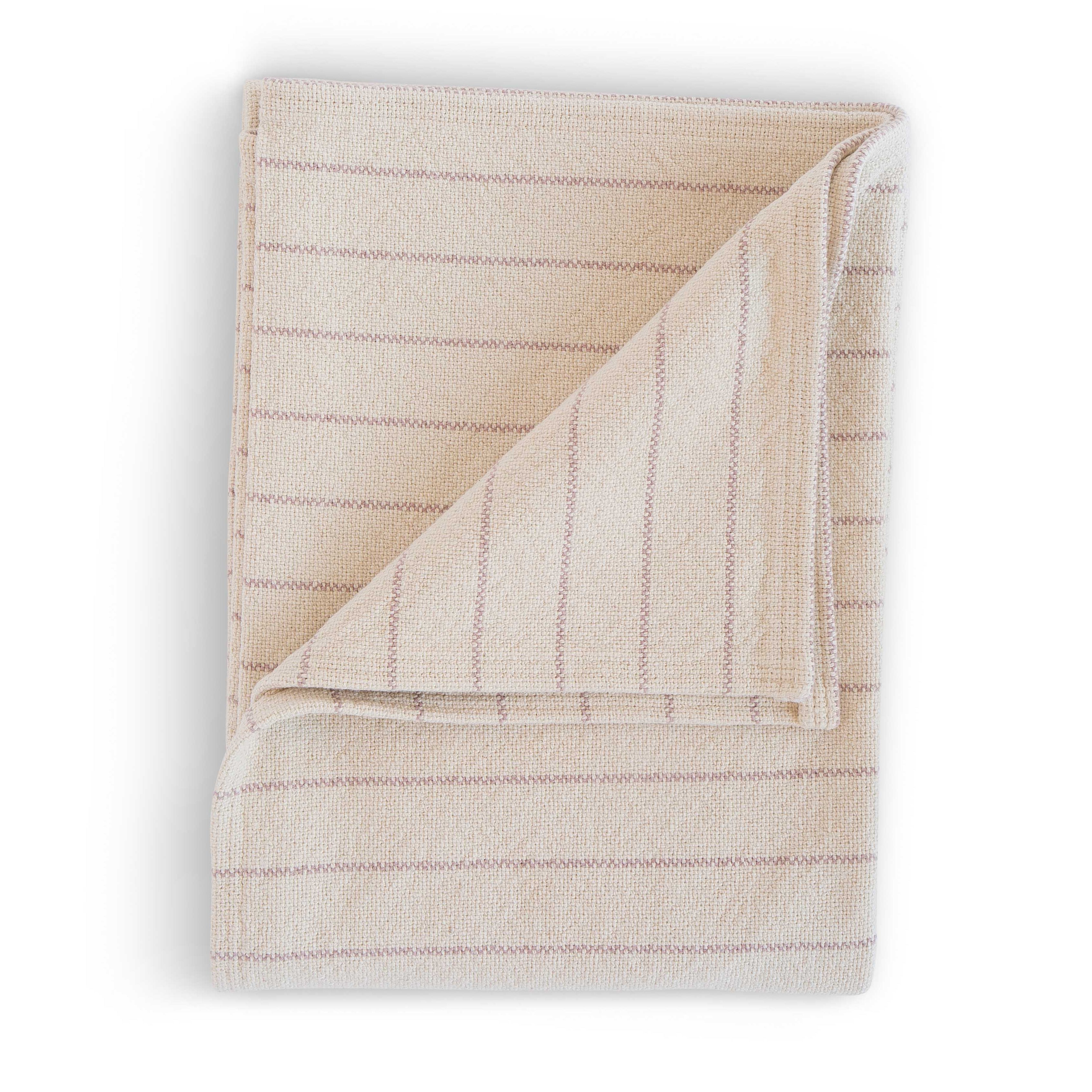 Folded beige blush blanket on a white background