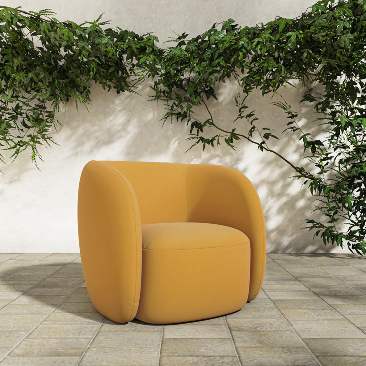 Yellow outdoor armchair on a stone floor with greenery in the background