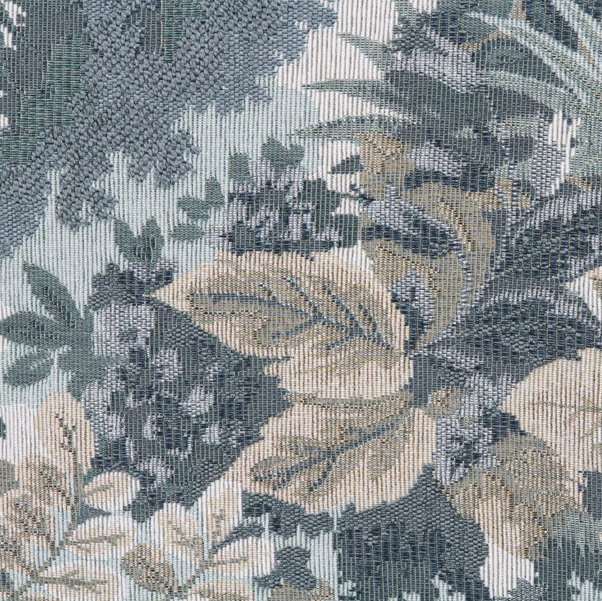 Close-up of a textured fabric with leaf pattern in shades of green and brown.