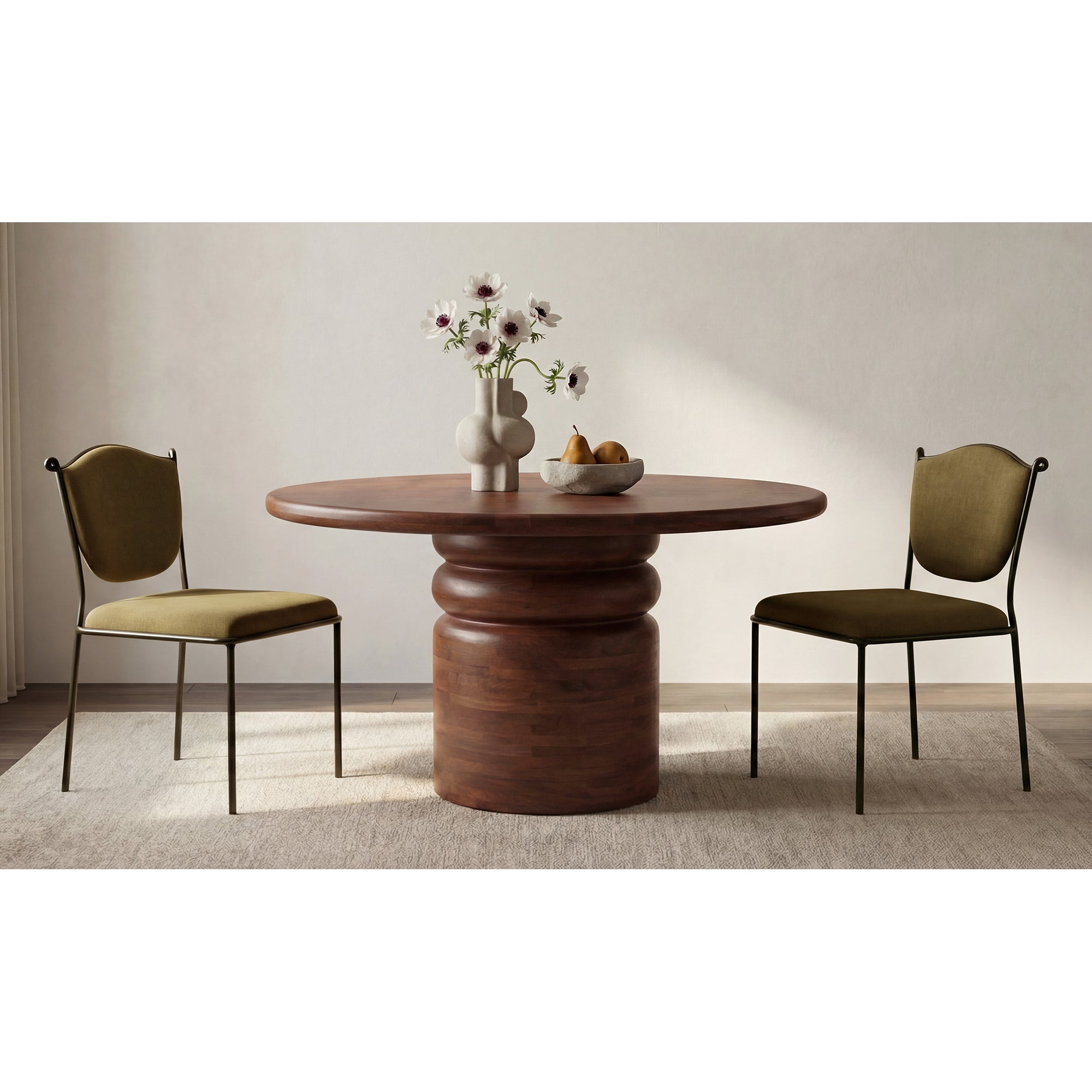 Round wooden dining table with two chairs in a minimalistic room.