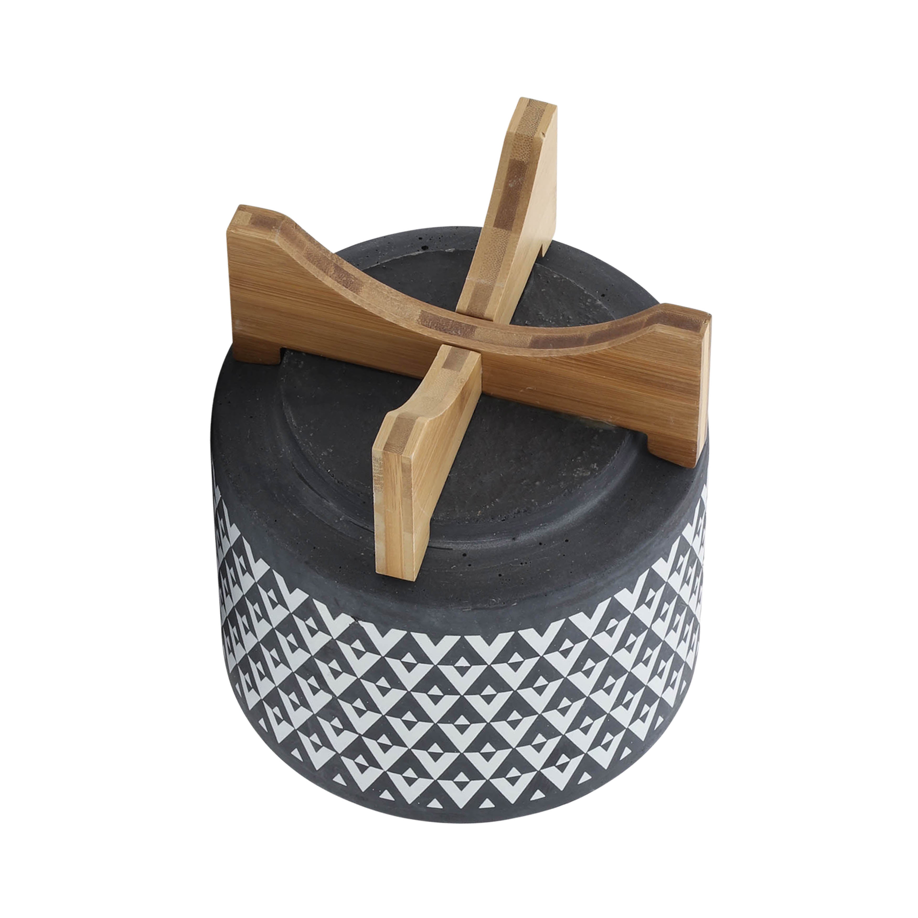 Decorative container with geometric pattern and wooden accents on a white background
