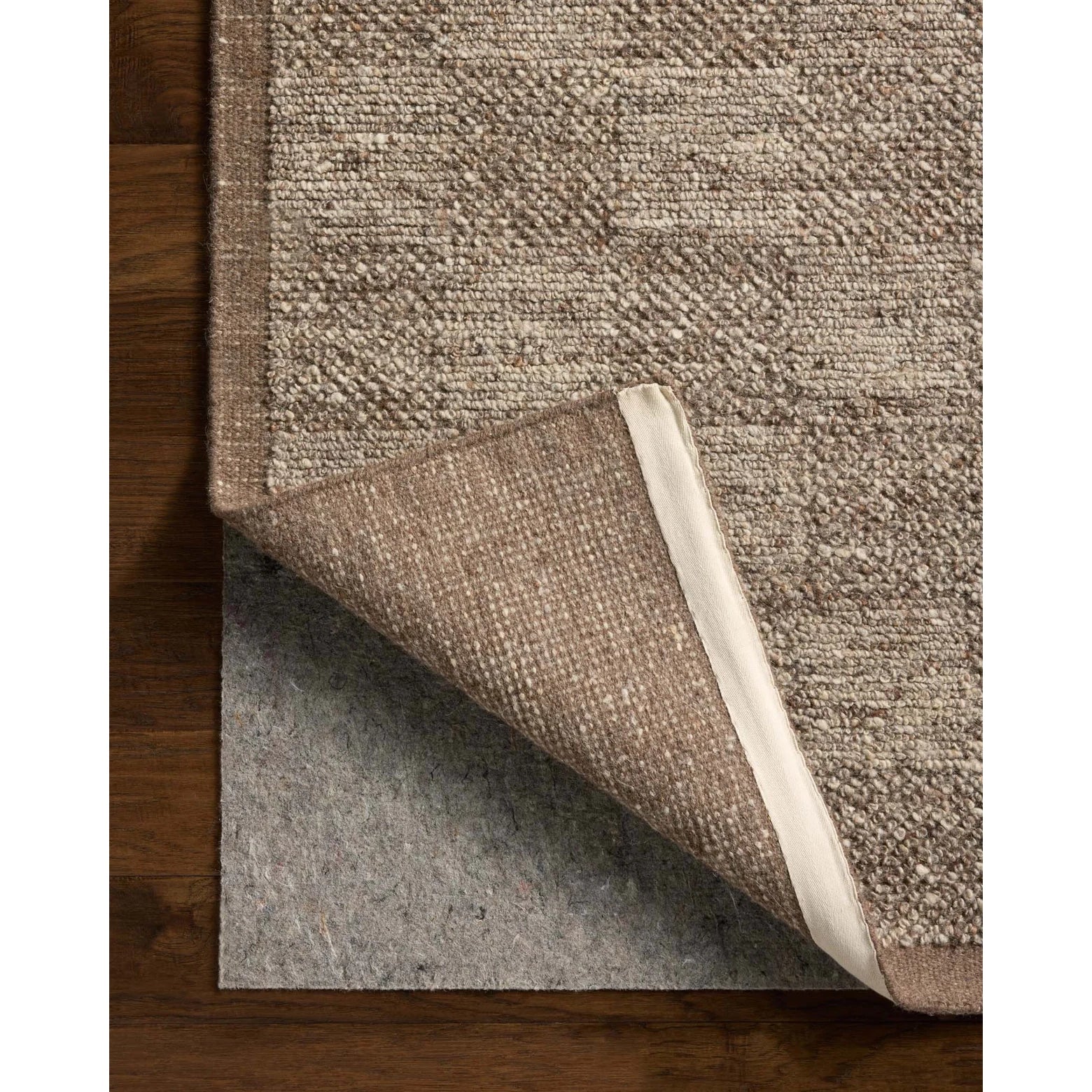 Brown textured rug on a wooden floor