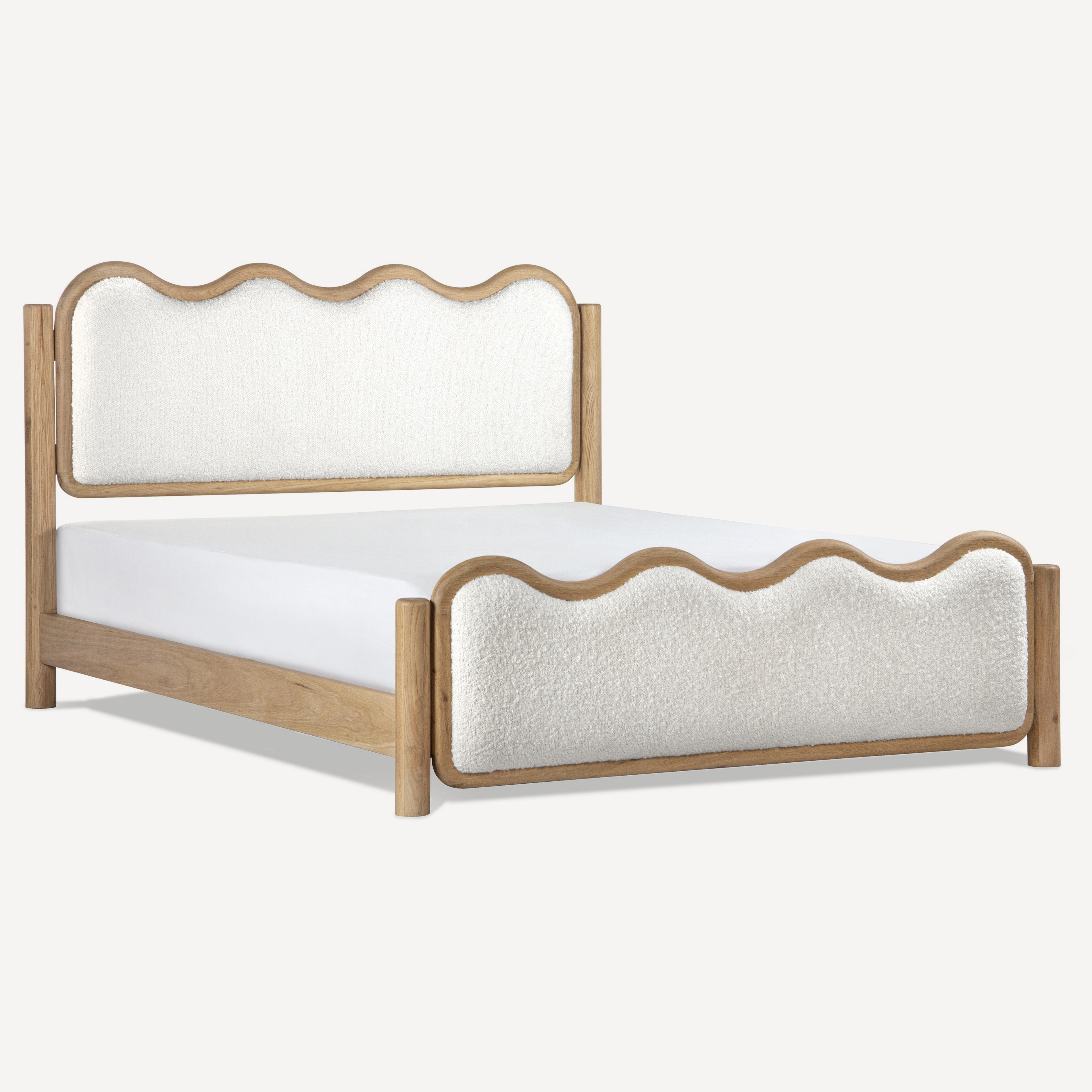 A wooden bed frame with scalloped upholstered headboard and footboard in a light beige fabric, shown on a plain light gray background.