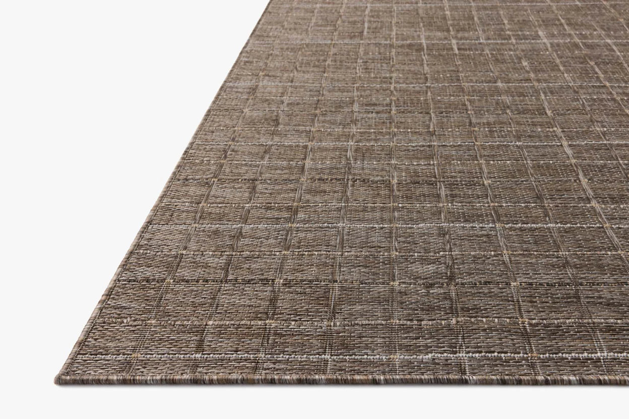 Close-up of a textured brown rug on a white background