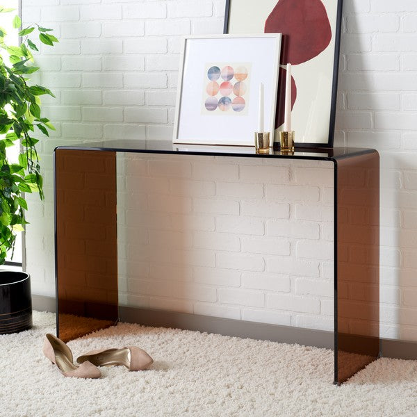 Modern console table with decorative items against a white brick wall.