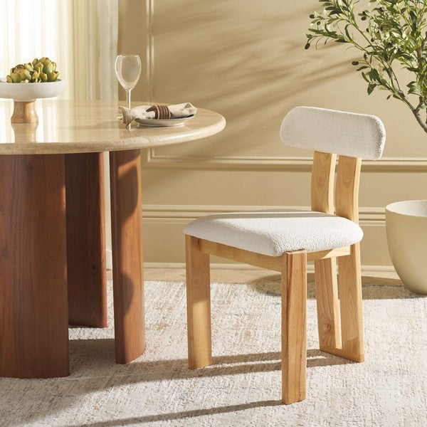 Wooden chair with a white cushion in front of a dining table.