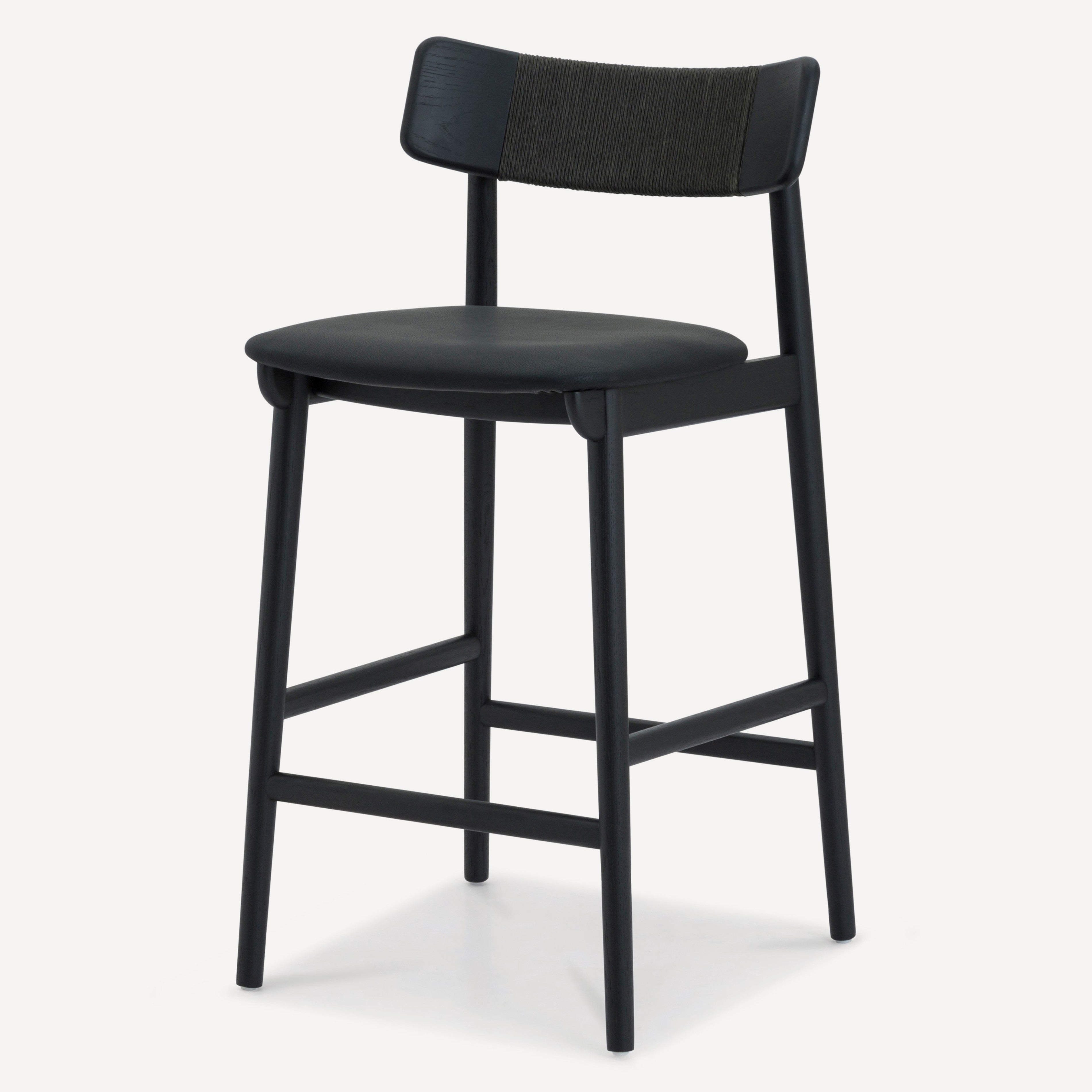 A modern counter stool with a black upholstered seat and a textured black-and-gray woven backrest, supported by a slim black metal frame with footrests, shown on a light gray background.