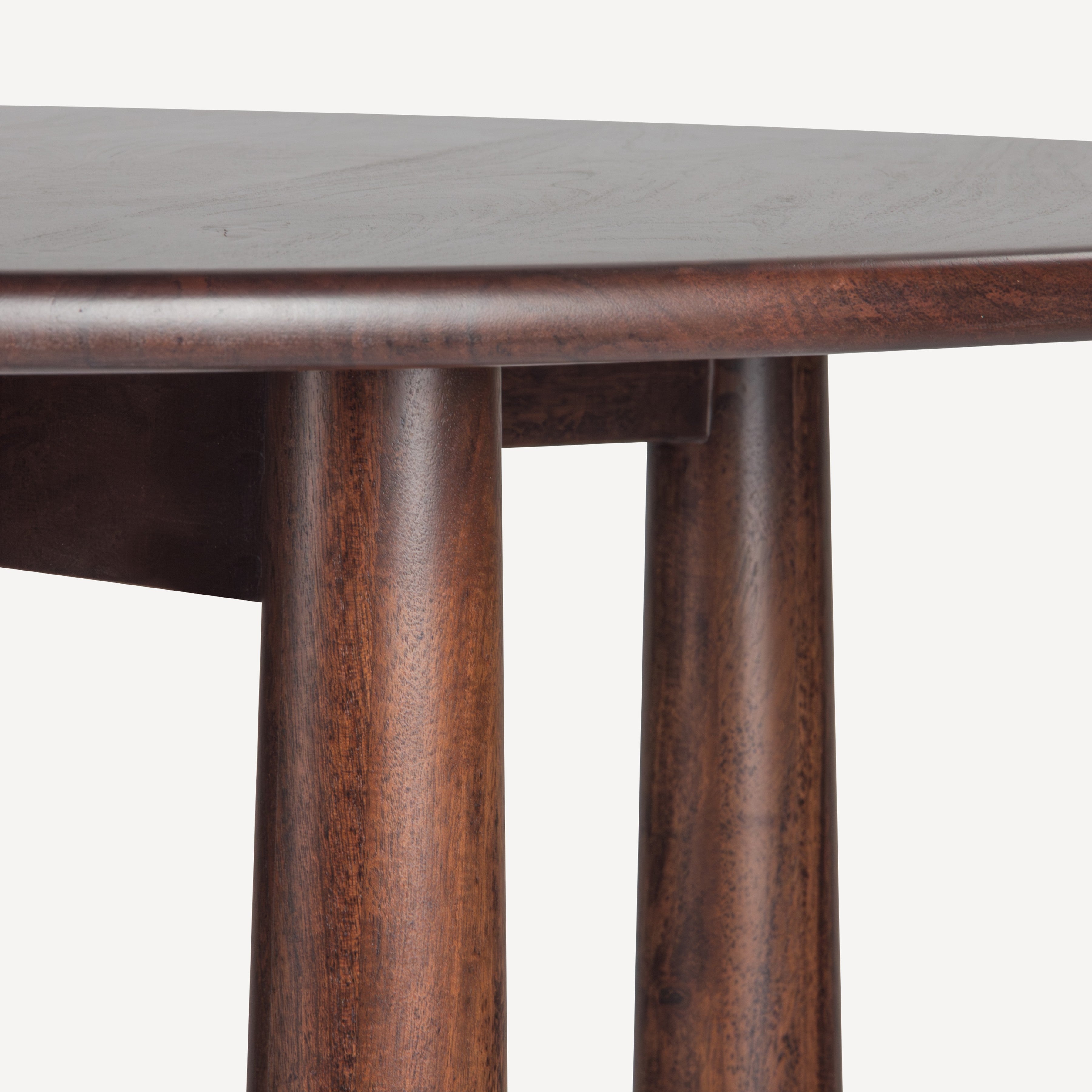 Close-up of a dark brown wooden table showing the tabletop edge, round profile, and two cylindrical legs with visible wood grain texture against a light gray background.