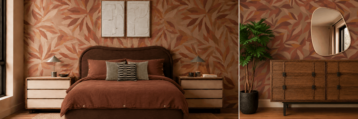 A styled bedroom interior featuring warm brown and rust wallpaper with a large leaf pattern, a dark upholstered bed with matching pillows, light wood nightstands, a wooden cabinet, wall art, and a potted plant.