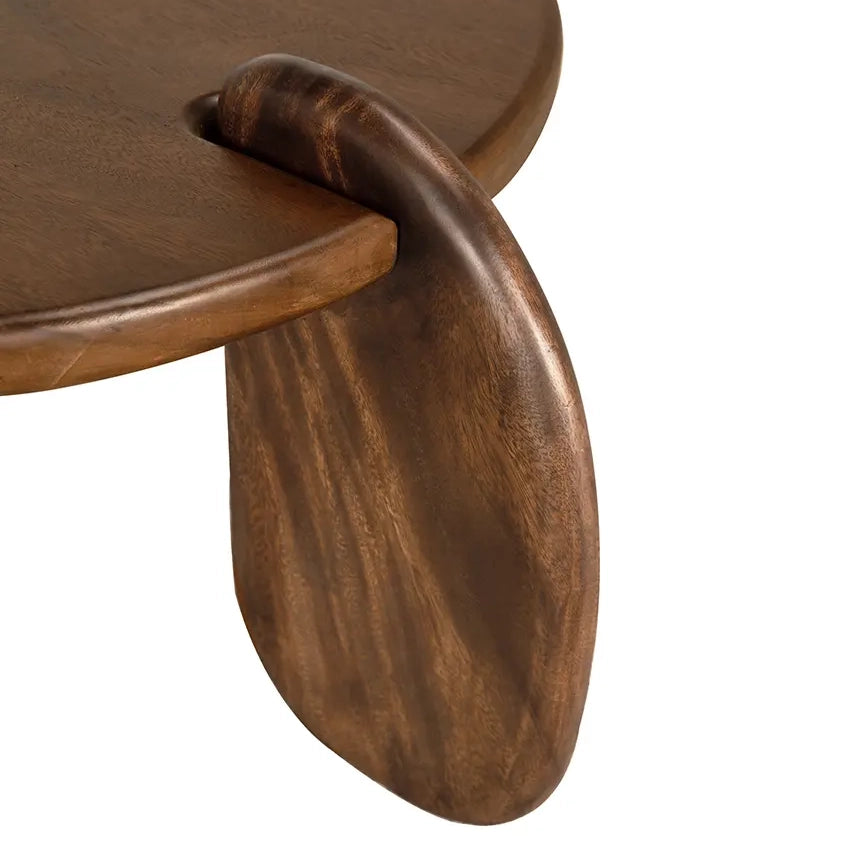 Close-up of a wooden coffee table with a curved leg on a white background
