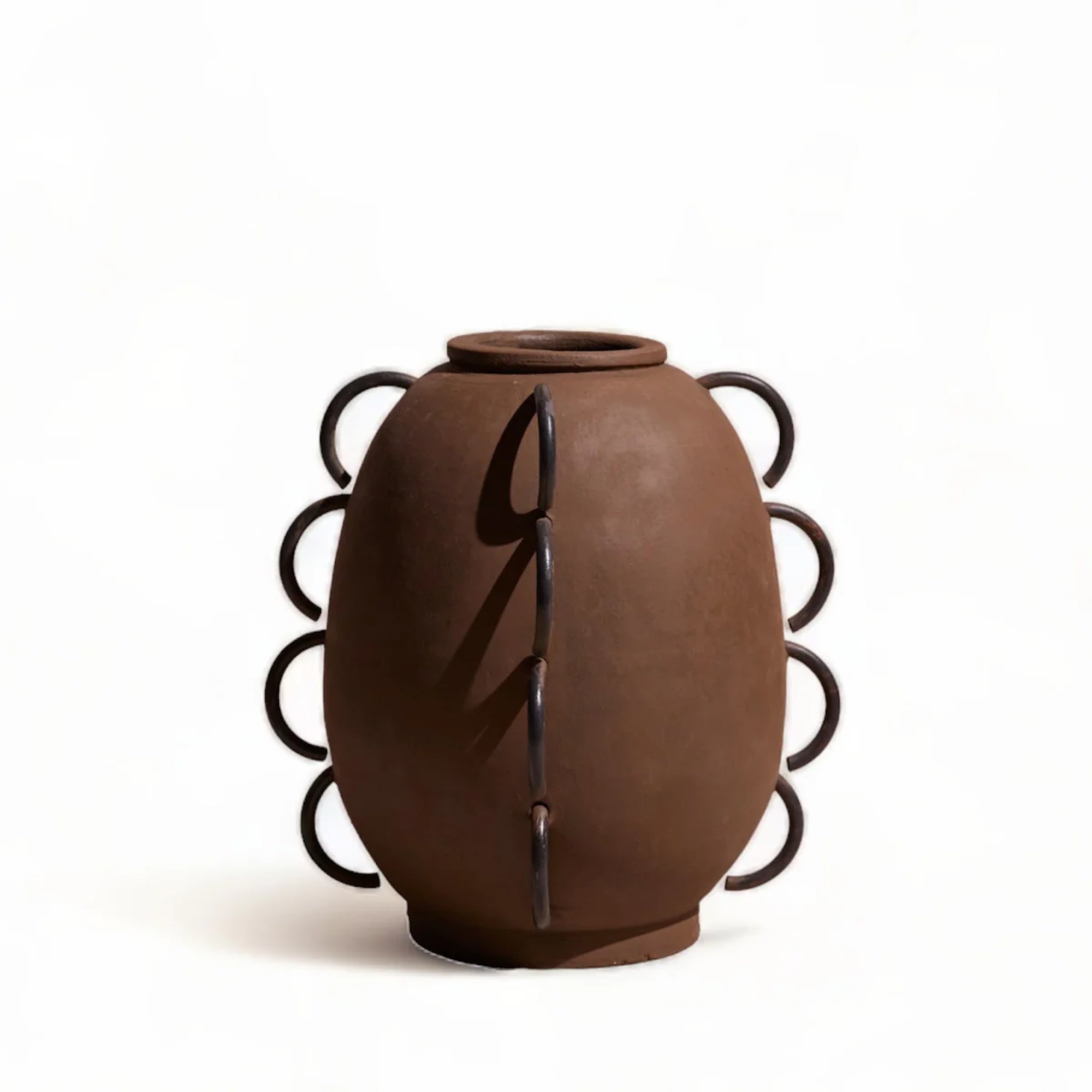 Brown ceramic vase with decorative black scalloped handles on a white background