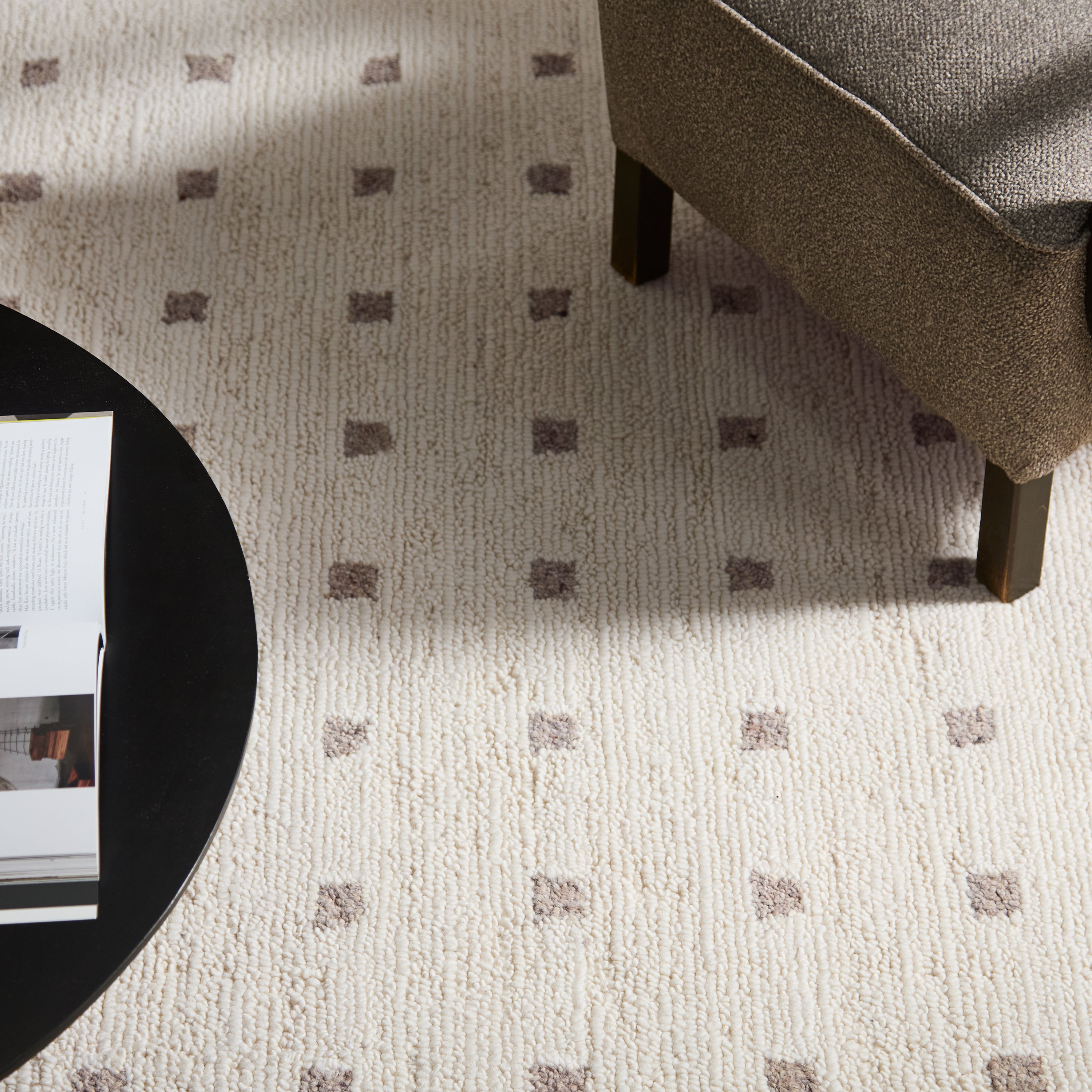 Patterned carpet with a chair and round table in a room setting