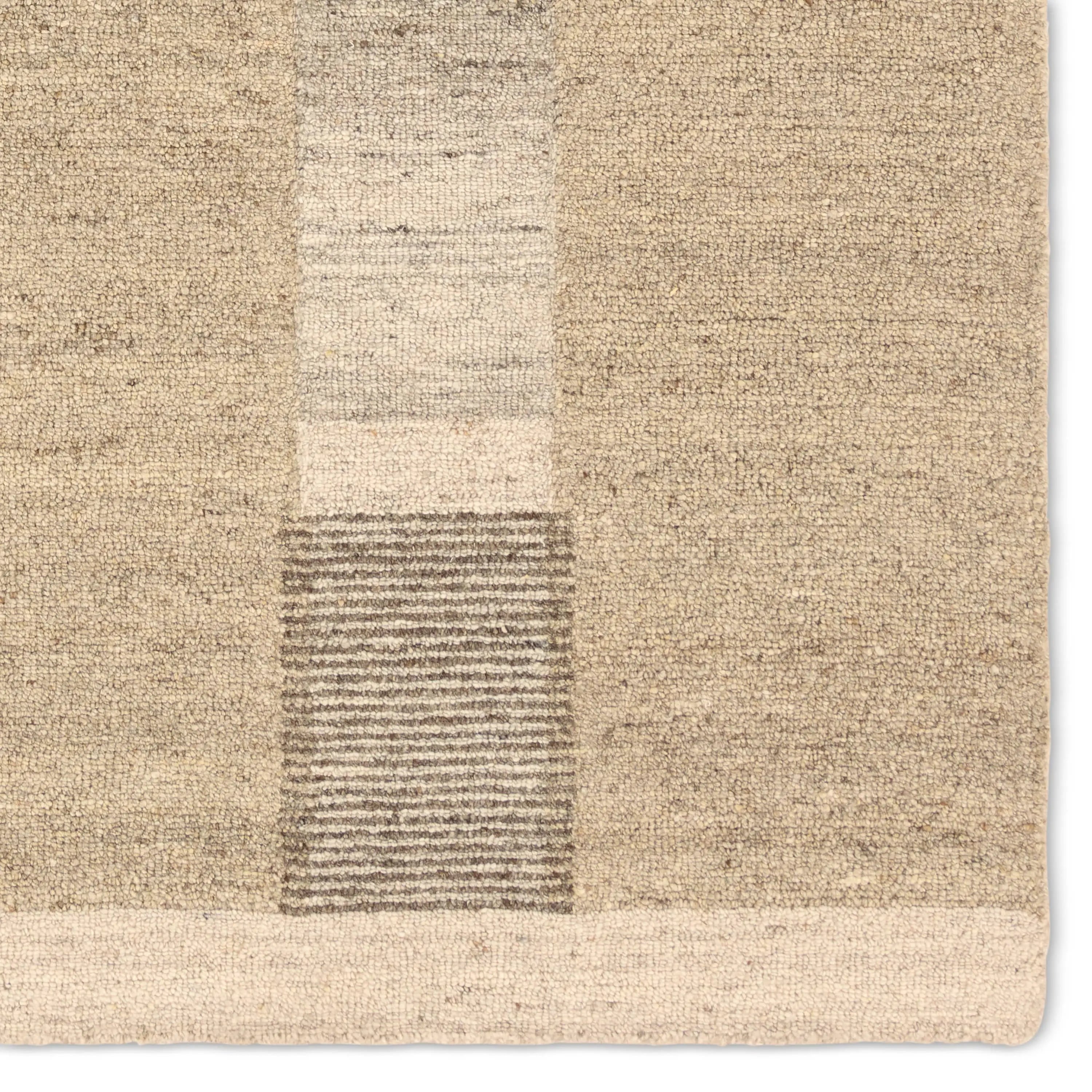 Close-up of a textured beige rug with a geometric pattern