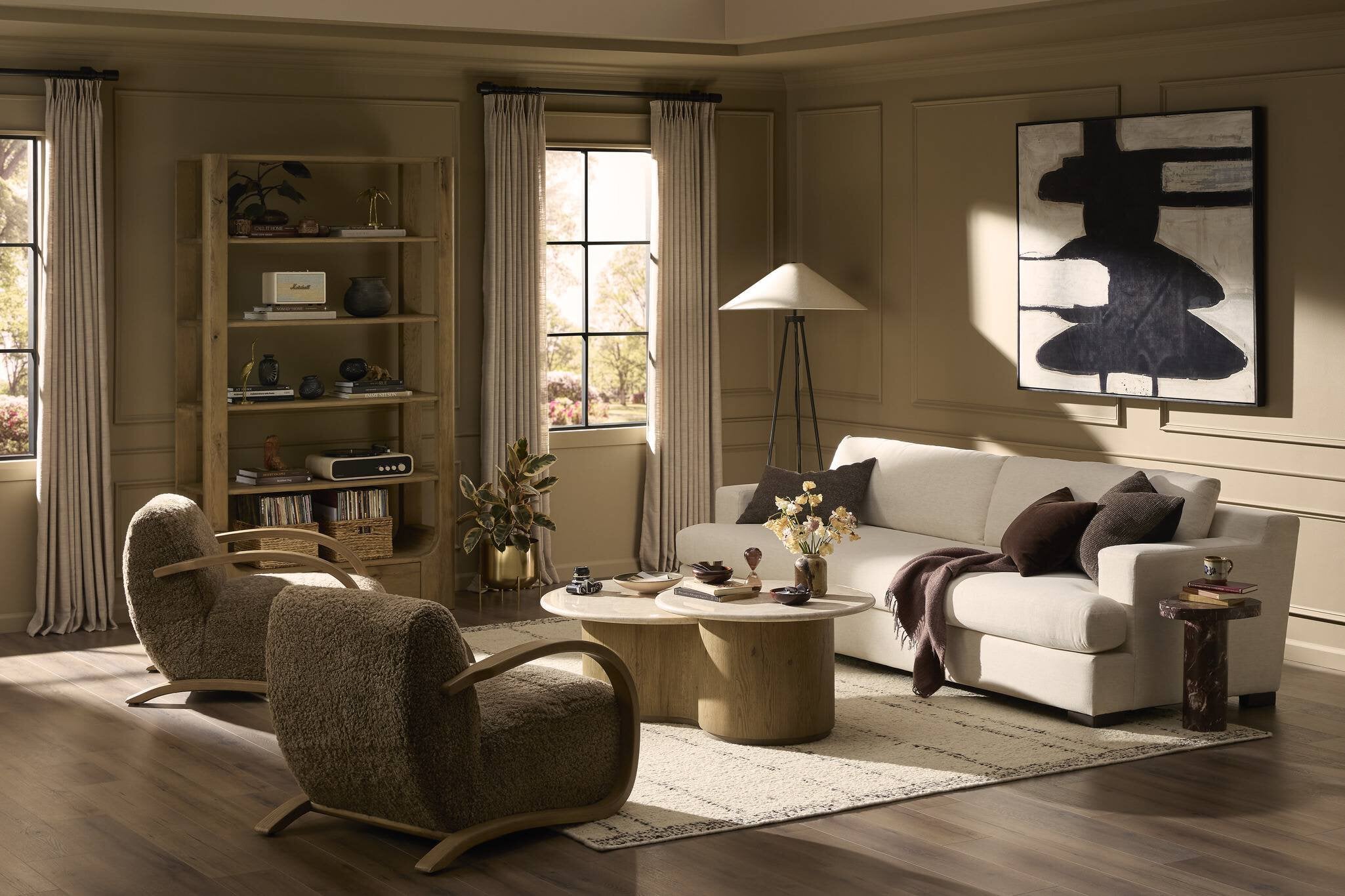 Modern living room with a sofa, armchairs, and decorative items.