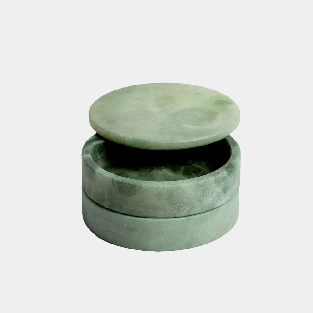 Green alabaster jewelry box with a lid on a white background