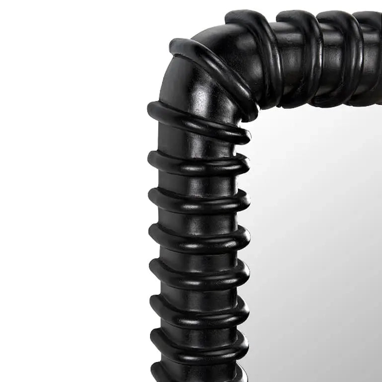 Close up of corner of black ribbed frame mirror on a white background