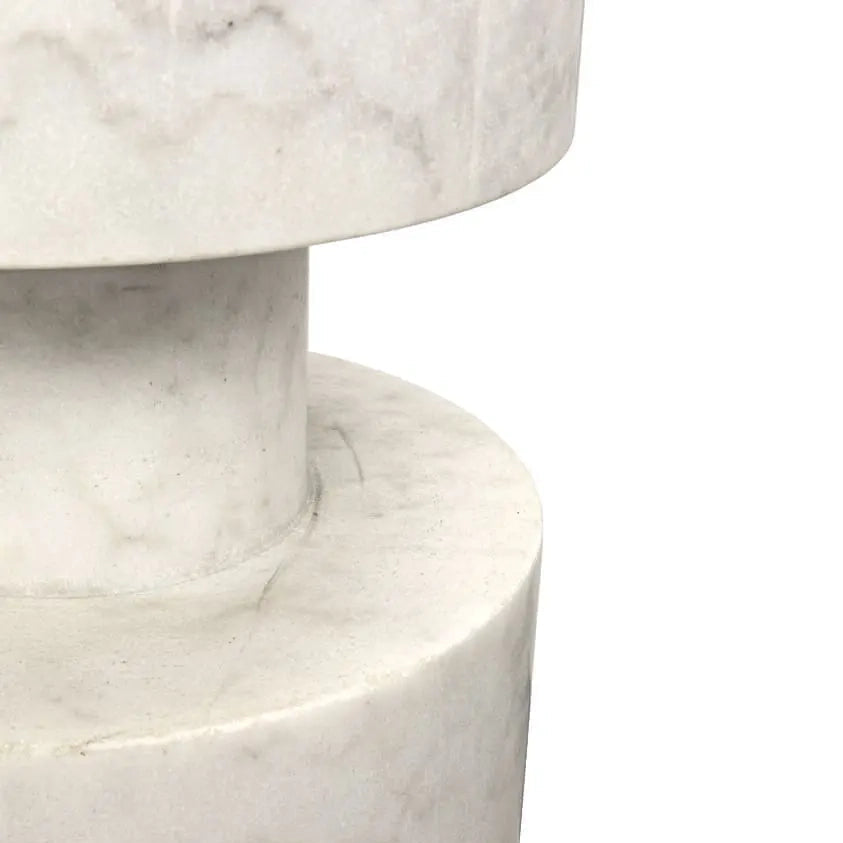 Close-up of a white marble cylindrical pedestal or table base with natural gray veining, shown against a plain white background.