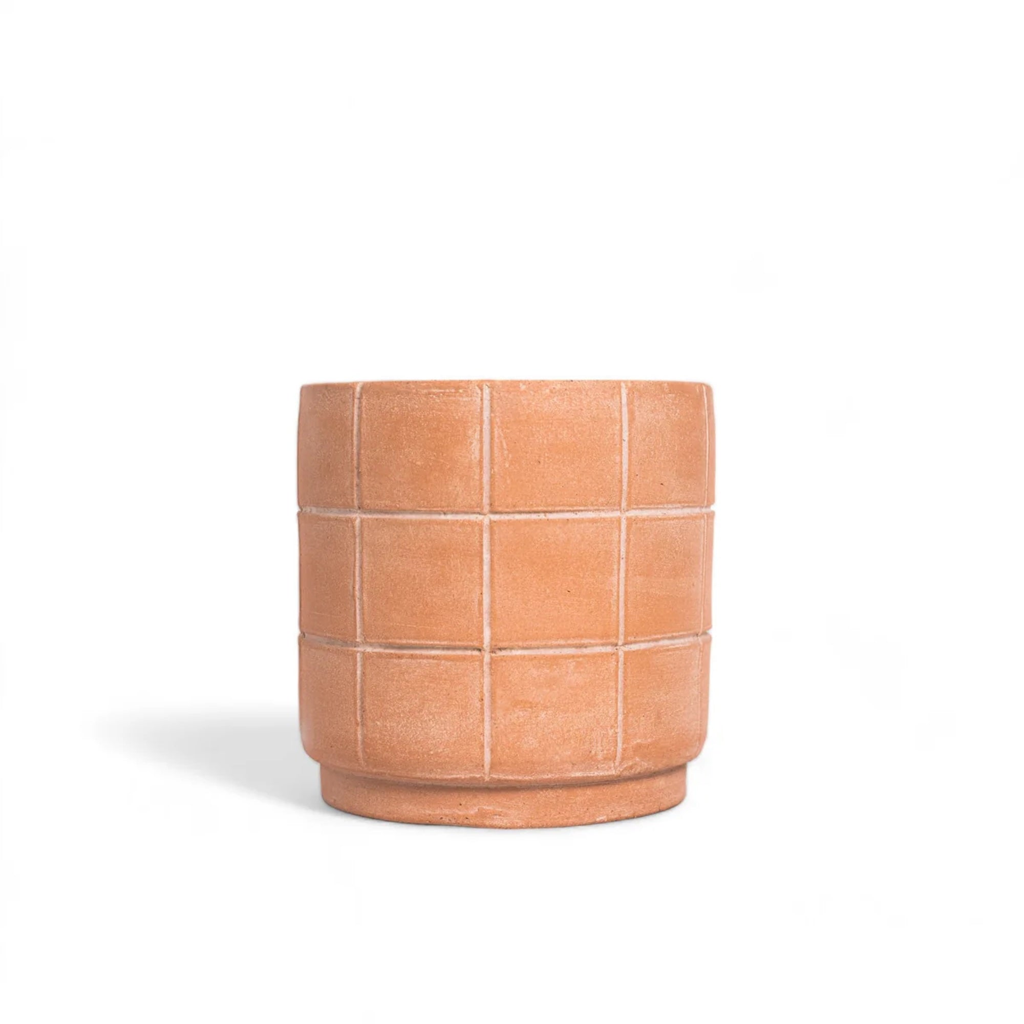 Terracotta-colored planter with grid pattern on a white background