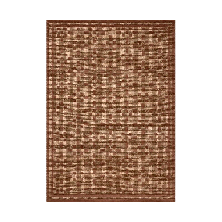 A rectangular, handwoven area rug with a geometric pattern in a natural brown color.
