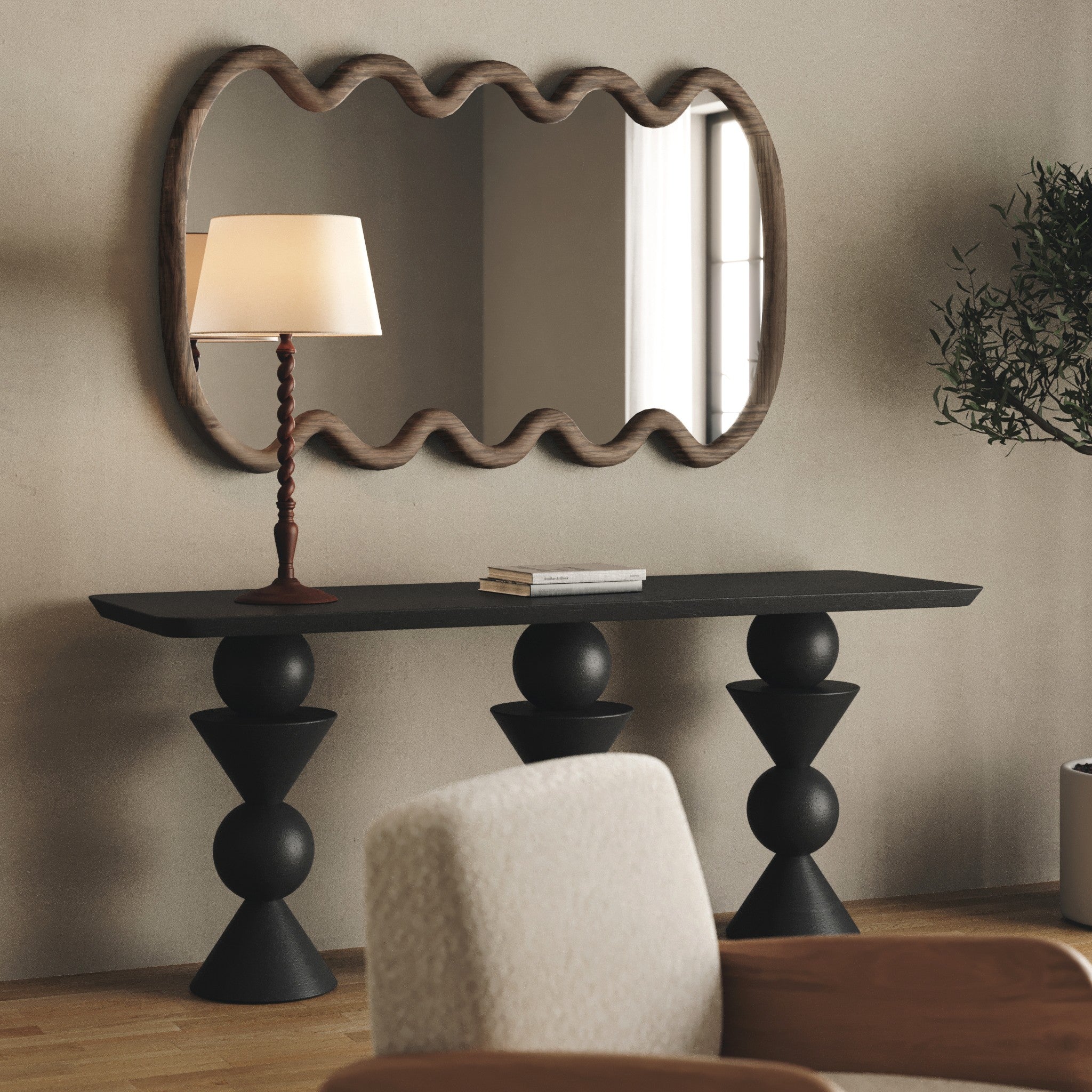 Console table with wavy mirror and lamp in a room setting