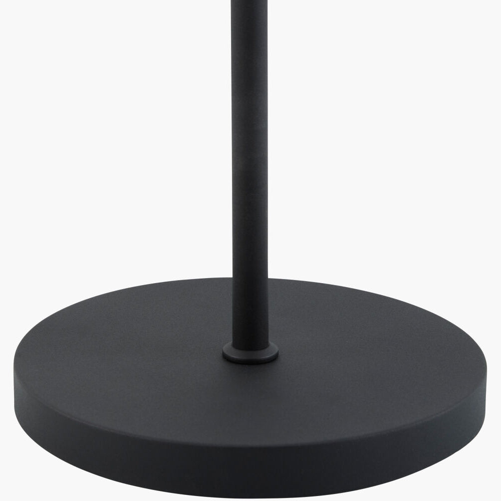 A close-up of a matte black metal stand or lamp base with a circular platform and central vertical pole, shown against a plain white background.