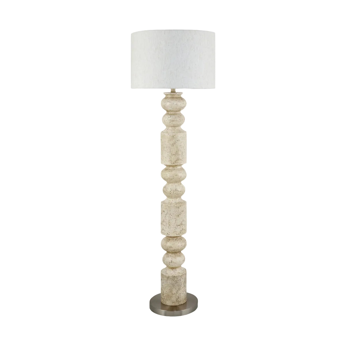A tall floor lamp with a textured off-white fabric drum shade and a sculptural, beaded column base made of a warm cream stone or resin, finished with a round brushed metal base.