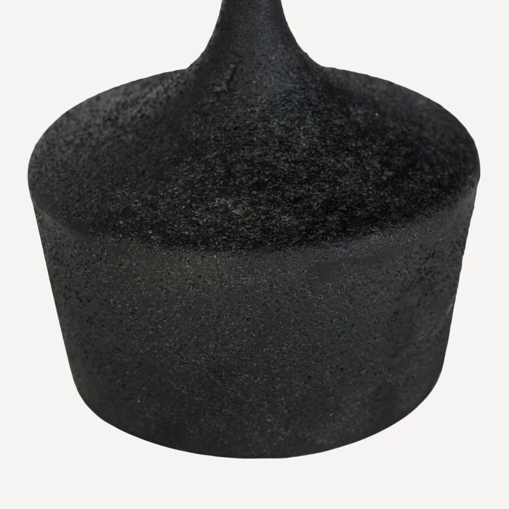 A close-up of a black pointed table base textured, matte finish, shown against a plain off-white background.