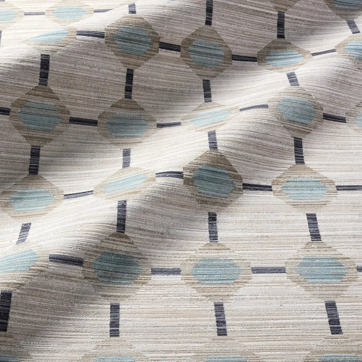 Patterned geometric rug with circular designs in beige, blue, and black.