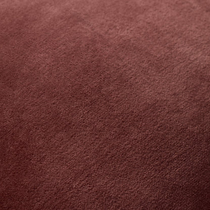 A square-shaped throw pillow with a solid wine color and a visible contrast welt edge treatment.