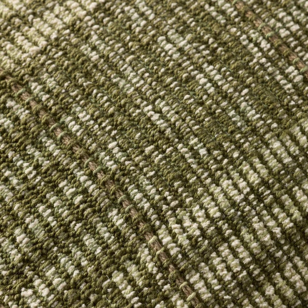 Close-up of a textured green fabric with a subtle pattern