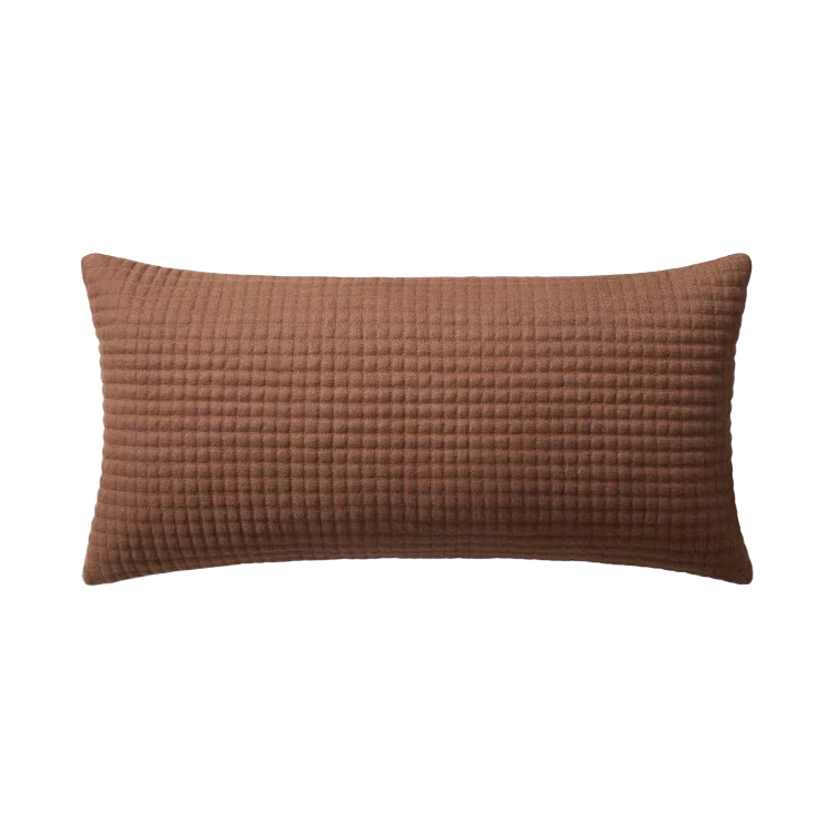 A rectangular lumbar pillow in a warm brown color, featuring a textured waffle or grid pattern, shown against a plain white background.