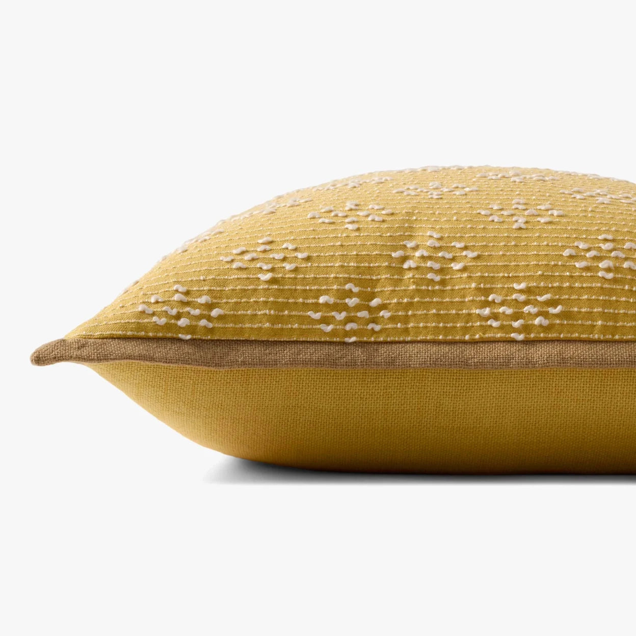 Yellow pillow with textured pattern on a white background