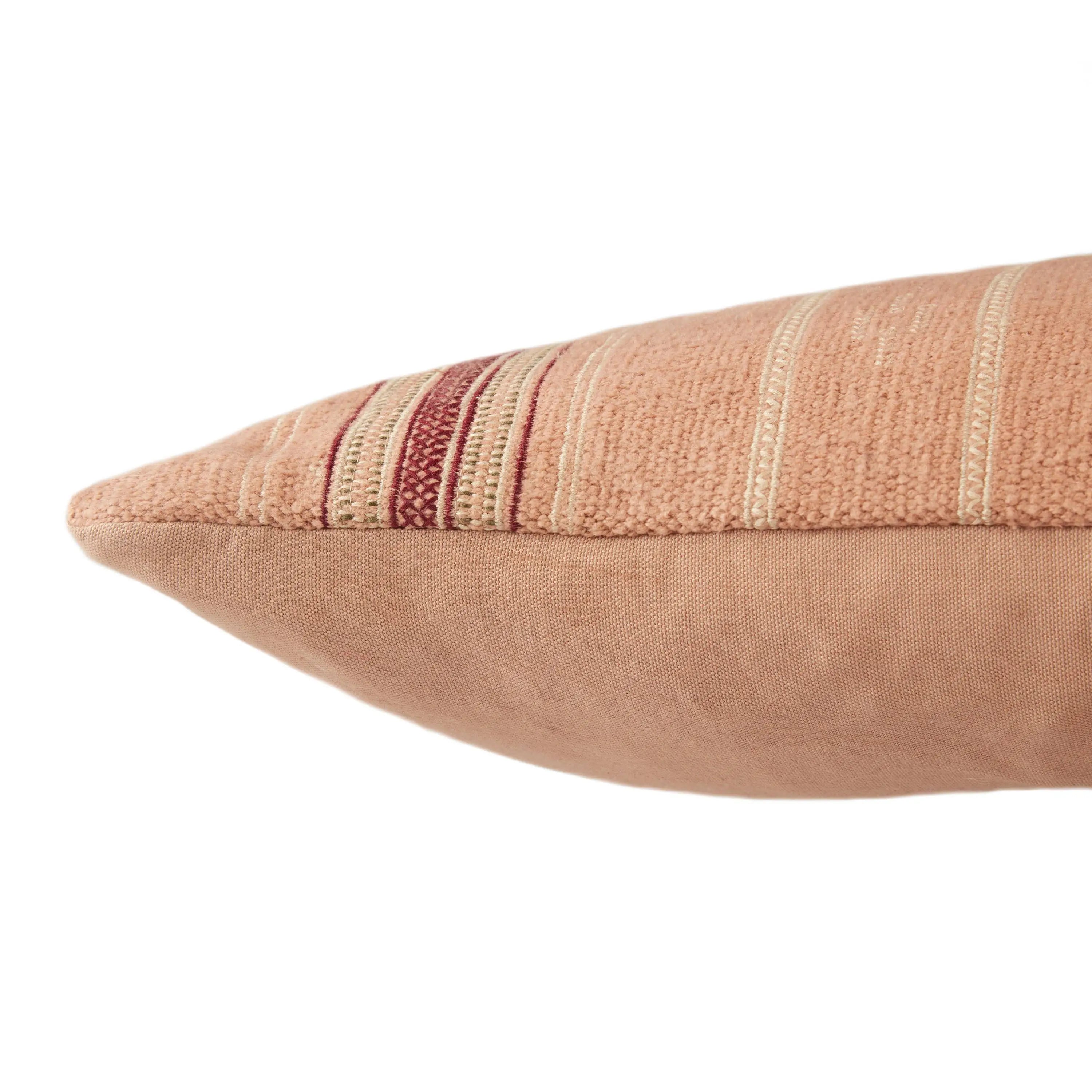 Textured pink and beige pillow with horizontal stripes on a white background