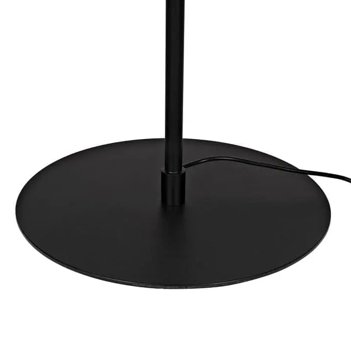 Close-up of a black floor lamp base with a circular metal platform, central pole, and visible power cord on a white background.