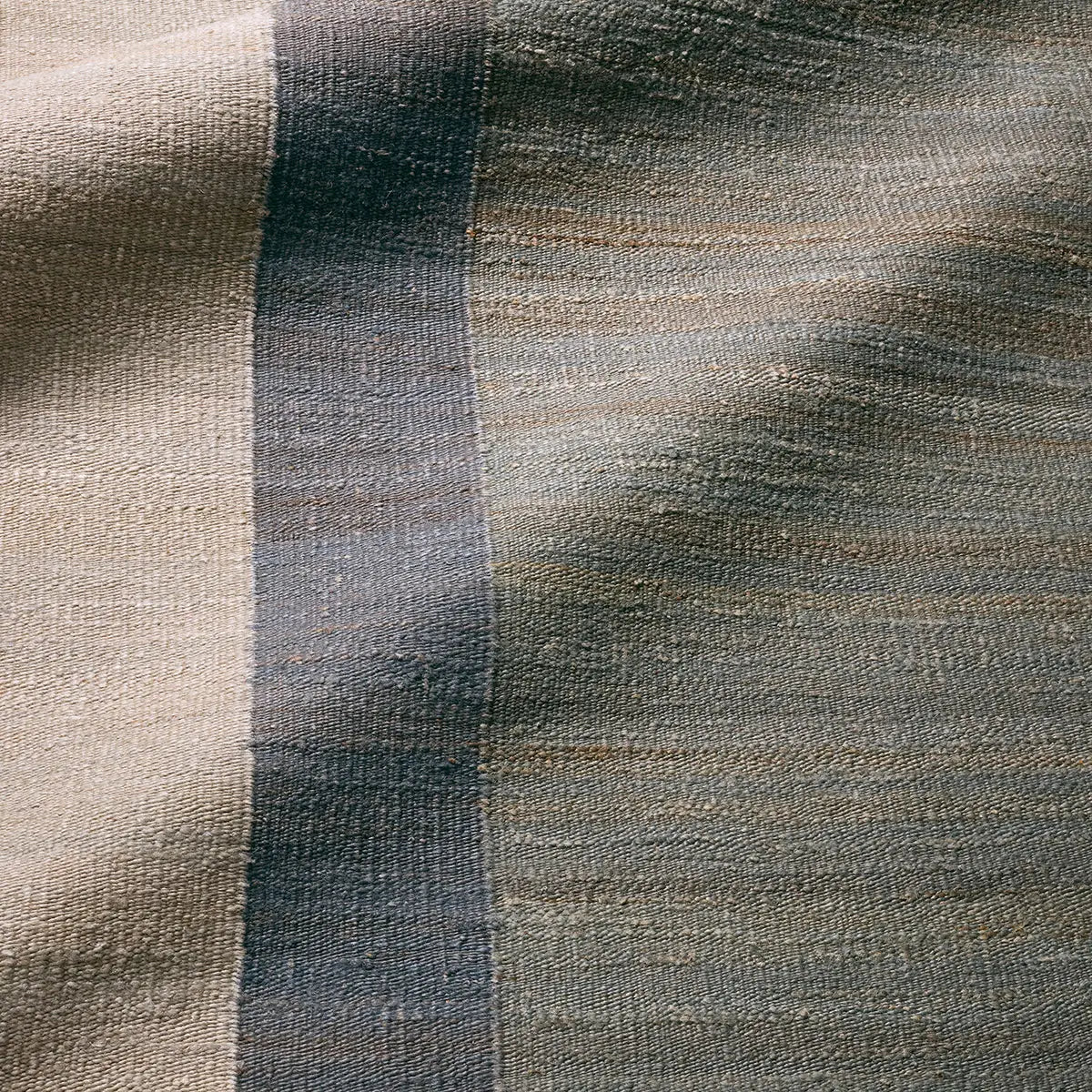 Close-up of textured fabric with a gradient of brown and gray colors.