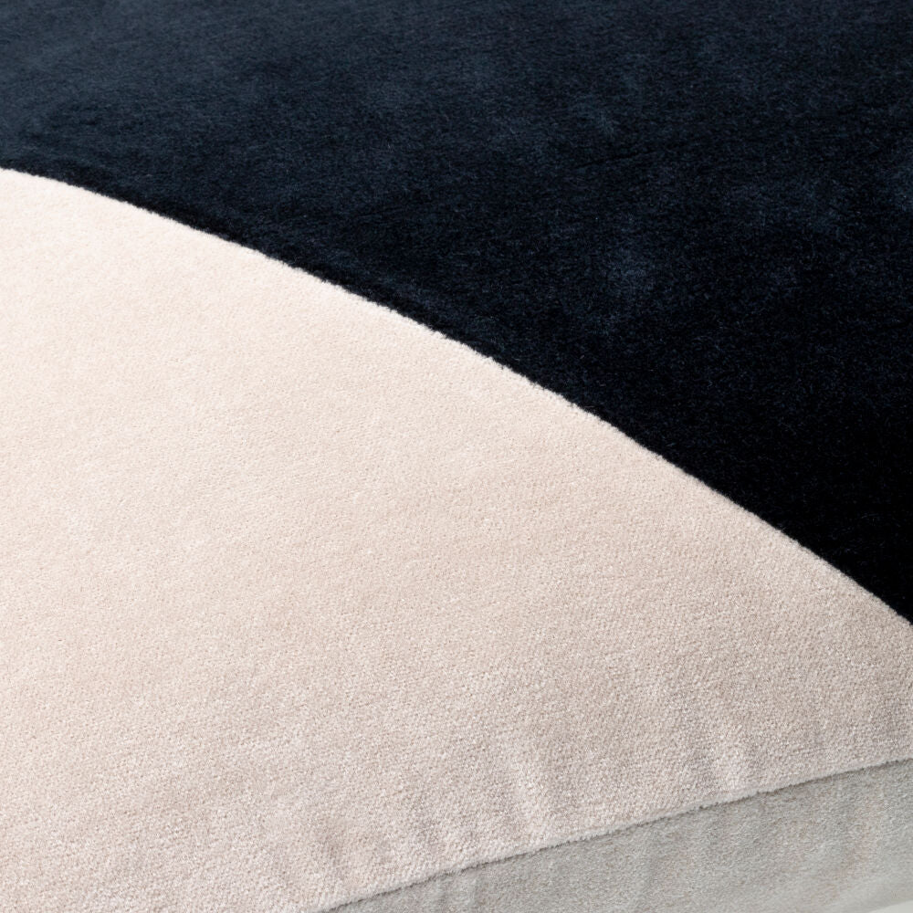 Close-up of a fabric with black, beige, and gray color blocks.