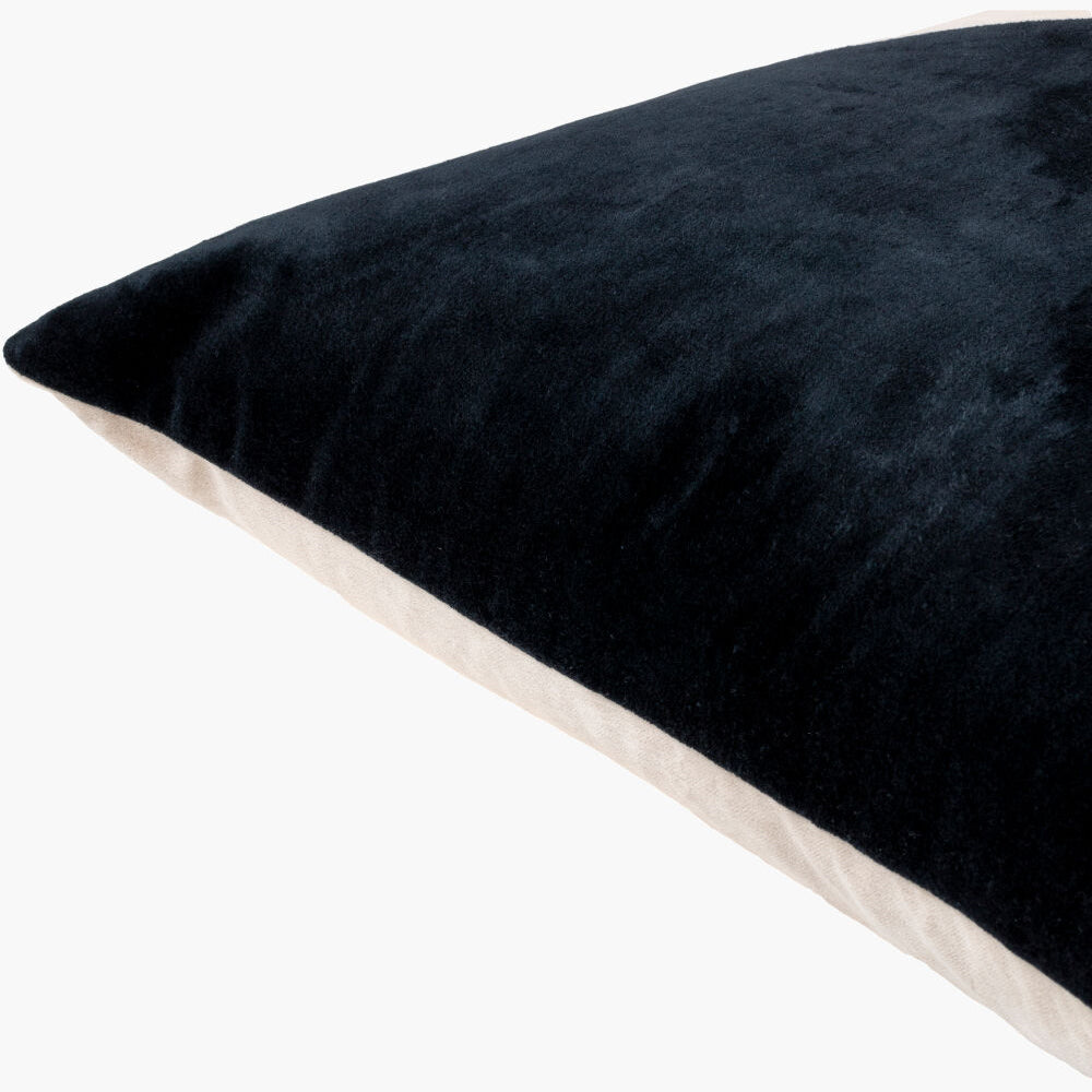 Black pillow with a textured surface on a white background