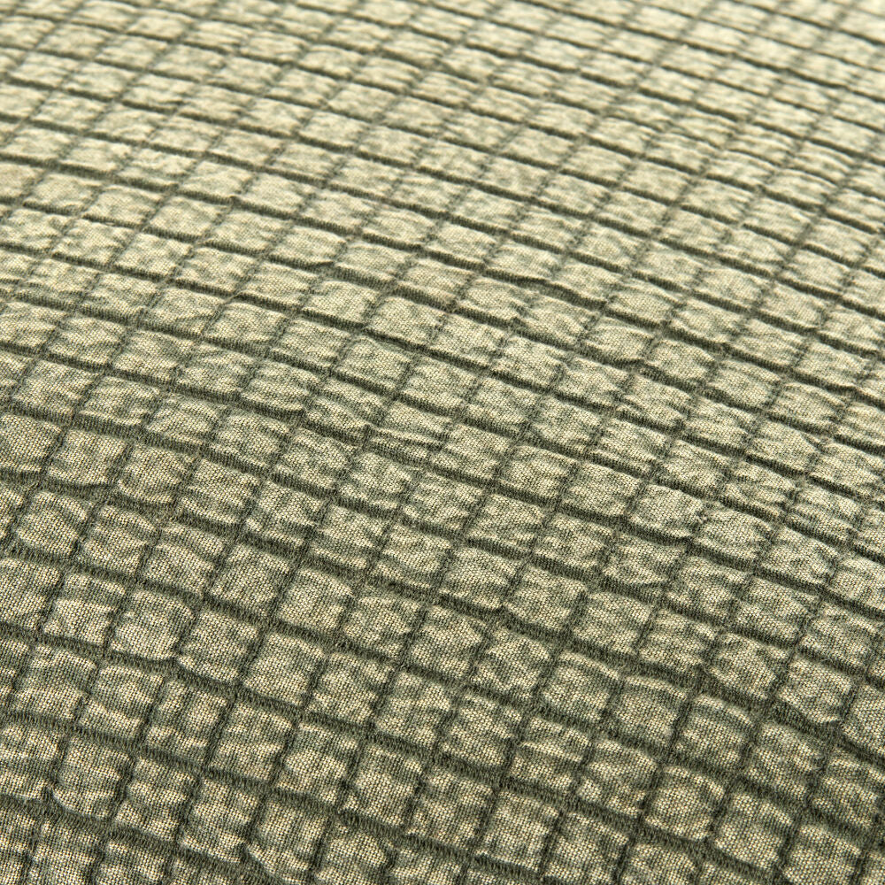 Close-up of a textured green fabric with a grid pattern