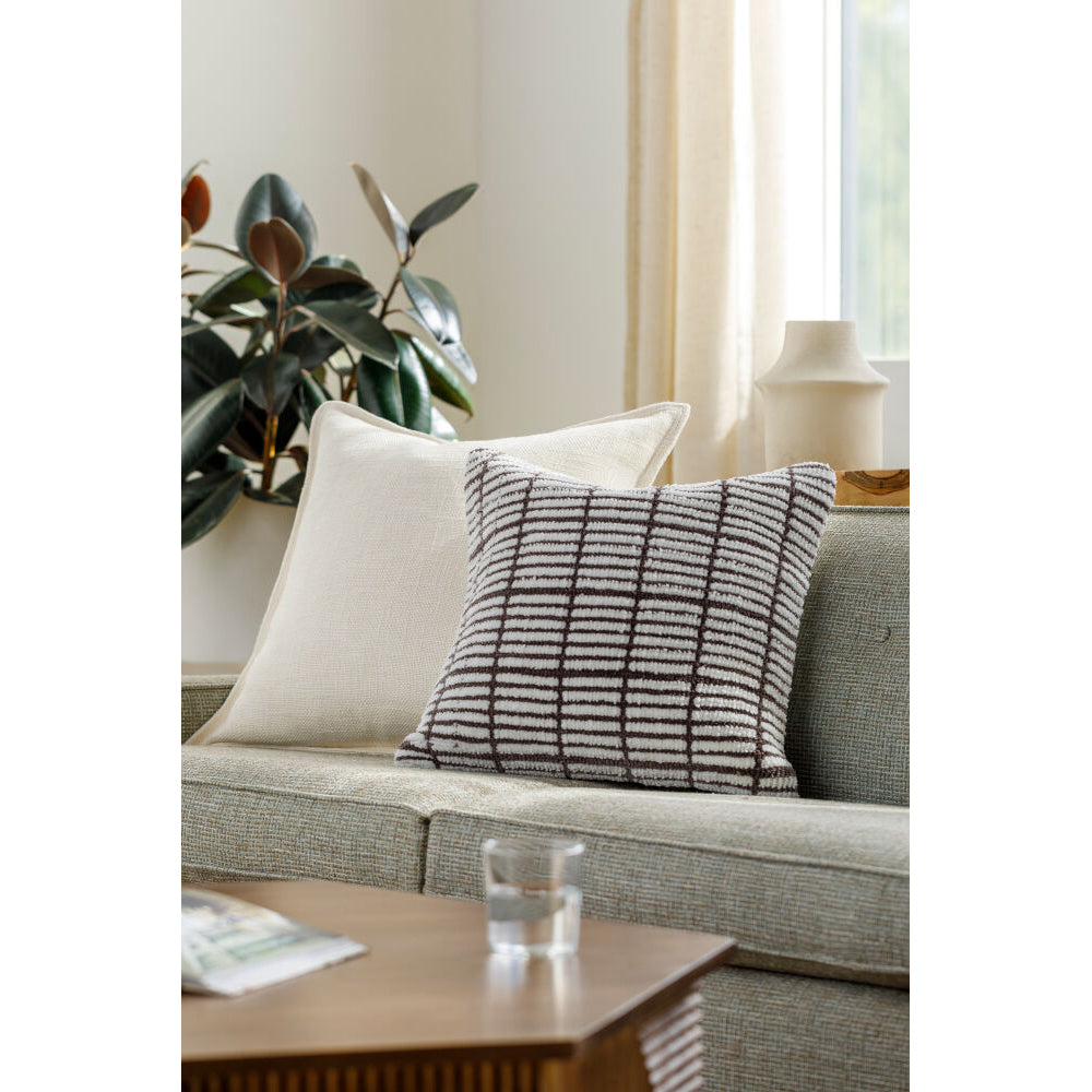 Gray sofa with a striped pillow in a living room setting