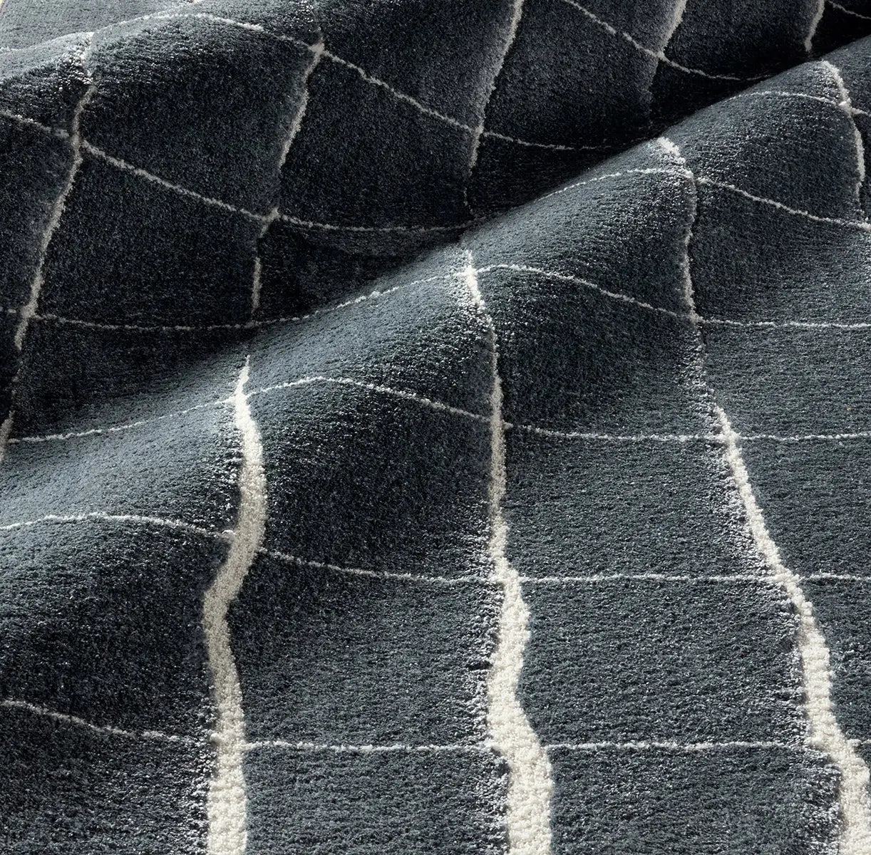 Close-up of a textured blue rug with a checkered pattern